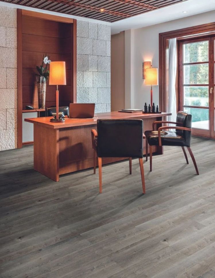 luxury vinyl floor in a home office with a desk, lamps and chairs