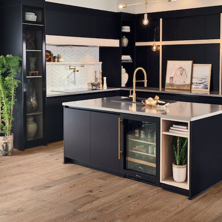 countertops in a kitchen with dark cabinets and gold hardware